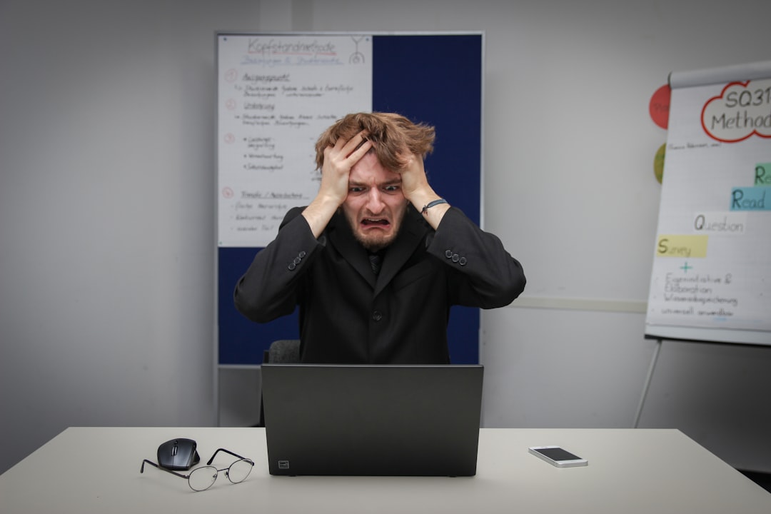 Trader managing emotions and stress during Forex trading session at computer desk